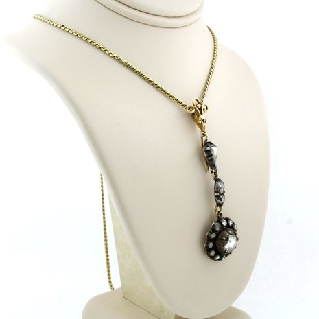 14k gold necklace with a gold and silver pendant set with rose cut diamonds