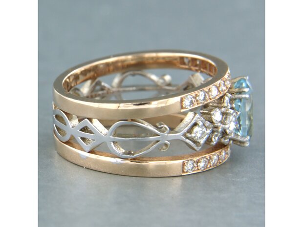 14k bicolour gouden band ring met centraal topaz en briljant geslepen diamant 0.75ct