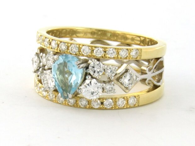 18k bicolour gouden band ring met centraal topaz en briljant geslepen diamant 0.92ct